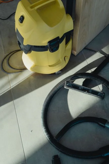 Window cleaners suspended on ropes clean a high-rise buildings glass exterior.